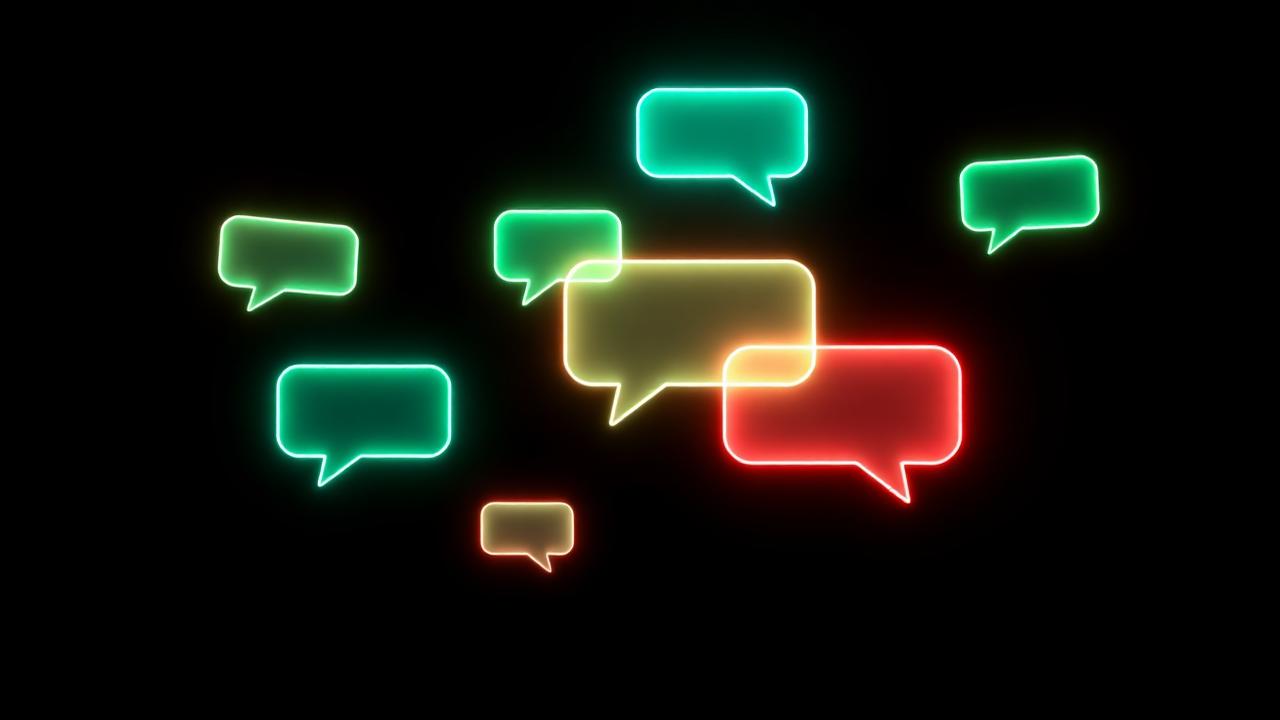 Glowing green and red neon chat bubbles floating on a dark background
